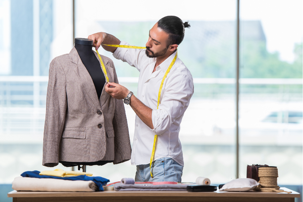A man measuring a jacket on a mannequin for a perfect fit.